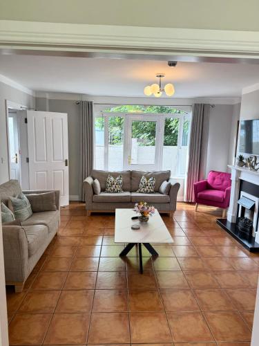 a living room with a couch and a table at Kerry Holiday Homes at the Killarney Holiday Village in Killarney