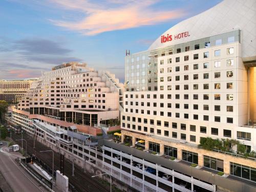 a large white building with a sign on top of it at ibis Sydney Darling Harbour in Sydney
