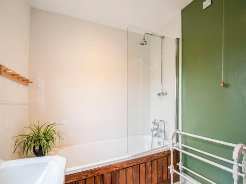 a bathroom with a bath tub and a shower at Beacon Cottage in Ilkley