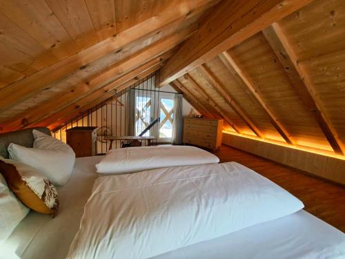 a bedroom with a bed in a attic at Praterhof Chalet in Südtirol - Natur, Ruhe & Bergblick in Bressanone