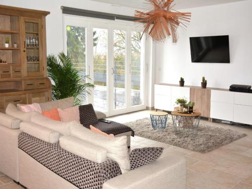 a living room with a couch and a tv at stunning Family Gîte Retreat in Stoumont