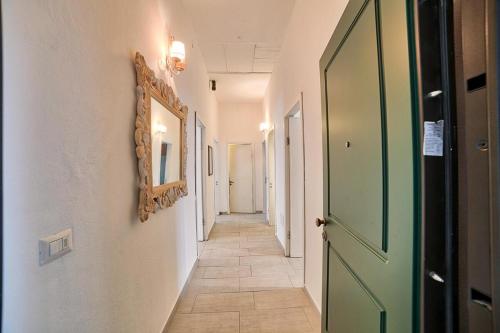 a hallway with a green door and a tile floor at Lemon Home in Olbia