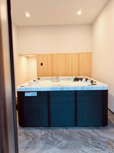 a bathroom with a tub in a room at Odaia Vanatorului Transalpina in Şugag