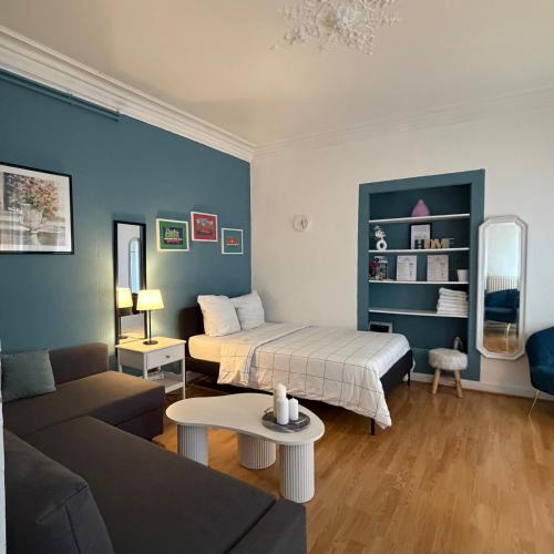 a living room with a bed and a couch at Hyper Centre Place Kléber Appart in Strasbourg