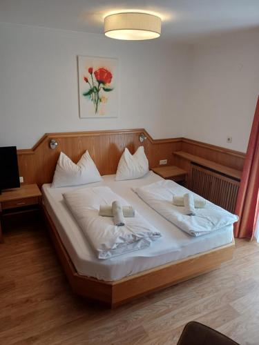 a bedroom with a bed with two pillows on it at B&B Kaiserstube in Flachau