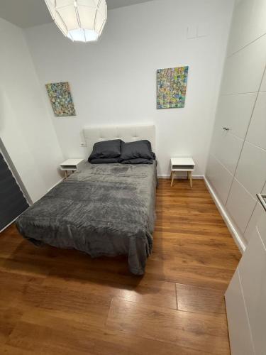 a bedroom with a bed and two side tables at Serenity Gelves in Gelves