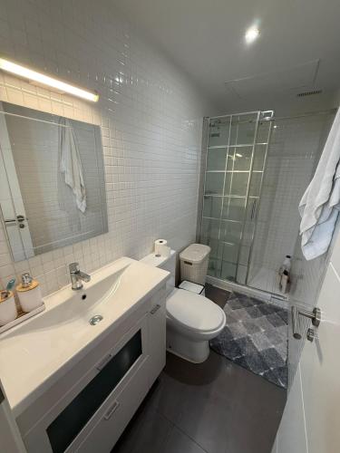 a bathroom with a sink and a toilet and a shower at Serenity Gelves in Gelves