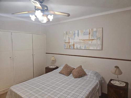 a bedroom with a bed and a ceiling fan at Lahogareña in La Cieneguita