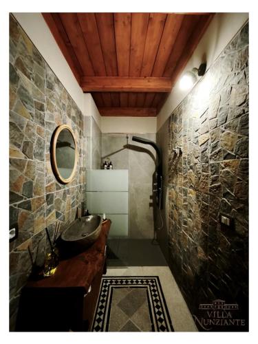 a bathroom with a sink and a stone wall at Villa Nunziante Grand Estate, Pompei in Scafati