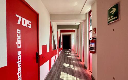 a hallway with a red door in a building at Hot Elite - Love Hotel - Solo Adultos in Mexico City