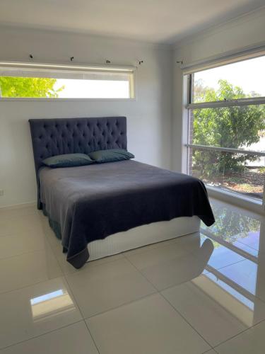a bedroom with a bed and a large window at Master's bedroom in Mount Duneed in Mount Duneed