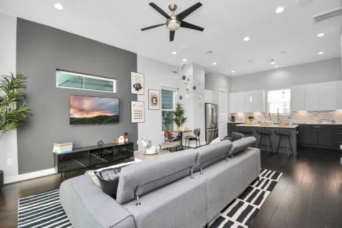 a living room with a couch and a kitchen at Mohr Haus - Walk to NRG Stadium - Medical Center - Sleeps 8 in Houston