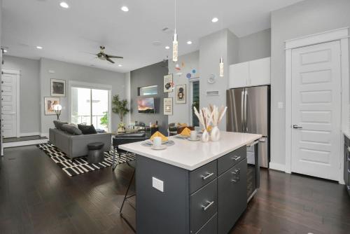 a kitchen and living room with a table and a couch at Mohr Haus - Walk to NRG Stadium - Medical Center - Sleeps 8 in Houston