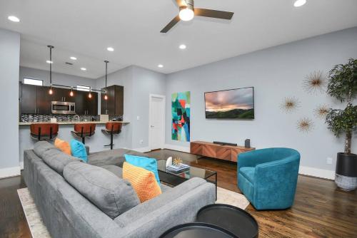 a living room with a gray couch and blue chairs at Skyline Views - Sleeps 10 Home Near Downtown in Houston