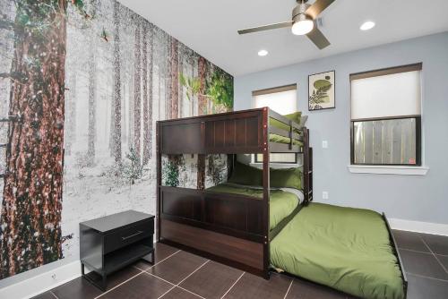 a bedroom with a bunk bed with green sheets at Skyline Views - Sleeps 10 Home Near Downtown in Houston