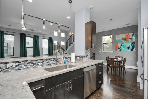 a kitchen with a sink and a dining room at Skyline Views - Sleeps 10 Home Near Downtown in Houston