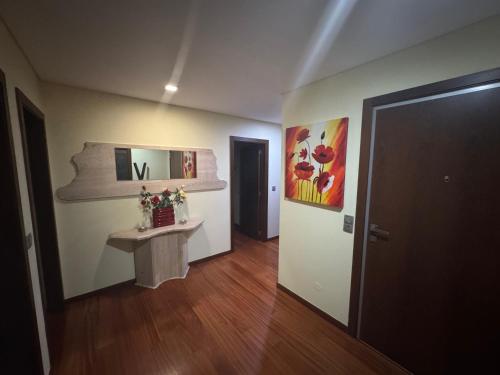 a room with a table and paintings on the wall at Vila Praia House in Vila Praia de Âncora