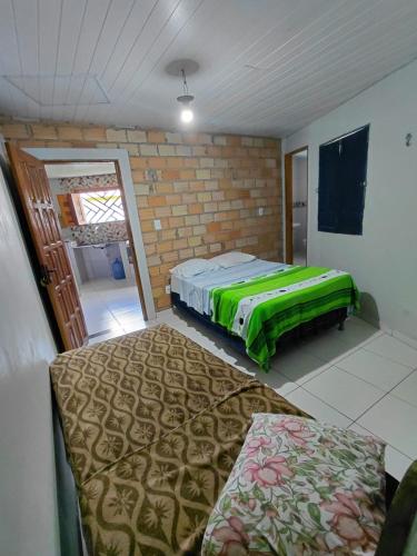 a room with a bed and a couch in it at SUÍTE Botos De Alter in Alter do Chao