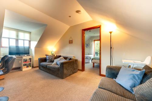 a living room with two couches and a television at The Loft at Duffryn Mawr Self Catering Cottages in Hensol
