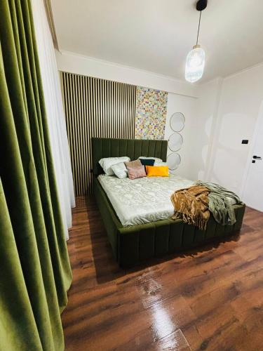 a bedroom with a bed with green curtains at GZP Residence Lugoj 4 in Lugoj