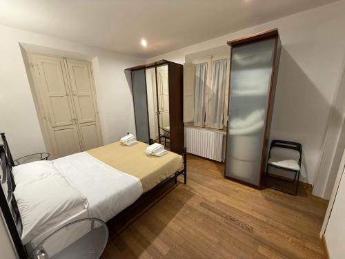 a bedroom with a bed and a chair in it at Sotto il Borgo Apartments in Iesi