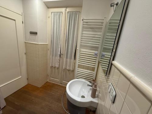 a white bathroom with a sink and a shower at Sotto il Borgo Apartments in Iesi