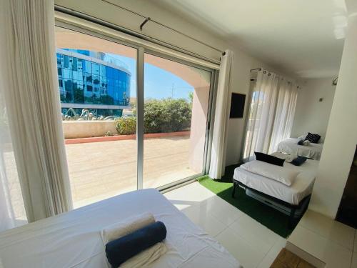 a bedroom with a bed and a large window at Sands in St. Julianʼs