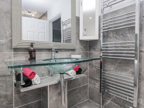 a bathroom with a sink and a mirror at Hazelodge in Coniston