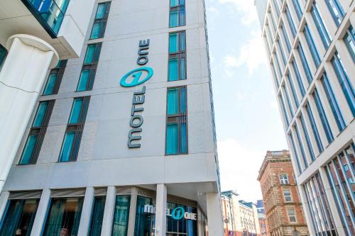 a building with a sign on the side of it at Motel One Manchester-St. Peter's Square in Manchester