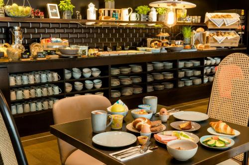 a table with plates of food on top of it at Motel One Linz-Hauptplatz in Linz
