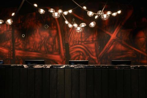 a stage with a red wall with lights on it at The Cloud One Gdansk in Gdańsk