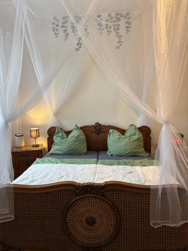 a bedroom with a bed with a canopy at Wohnen in der ehemaligen Bauernstube in Treia