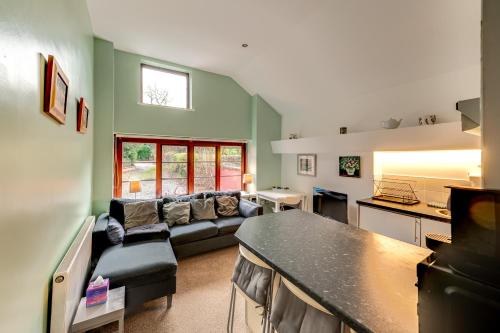 a living room with a couch and a table at Kingfisher Cottage at Duffryn Mawr Cottages in Hensol