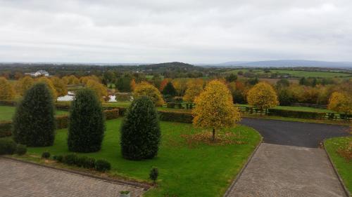 an aerial view of a park with trees and a road at Hazelwood Country House in Adare