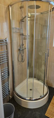 a shower with a glass door in a bathroom at Sandringham House in Stockton-on-Tees