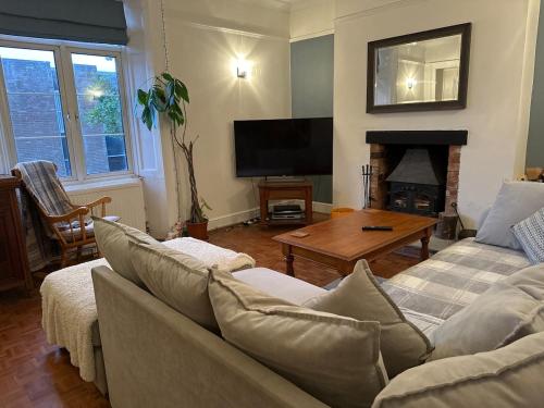 a living room with a couch and a coffee table at Gorgeous Henrietta in Exmouth