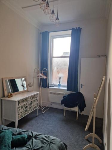 a bedroom with a mirror and a desk and a window at Baile Apartment Central Inverness in Inverness