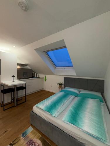 a bedroom with a large bed with a window at Modernes Dachgeschoss in Augsburg
