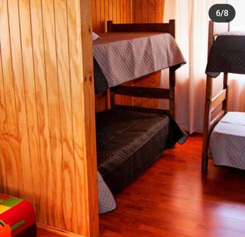 a room with two bunk beds in a room at Cabañas Biancomoro Olmue in Olmué
