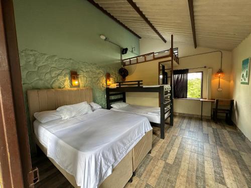 a bedroom with two beds and a bunk bed at New Western Llanos Stay in Acacías