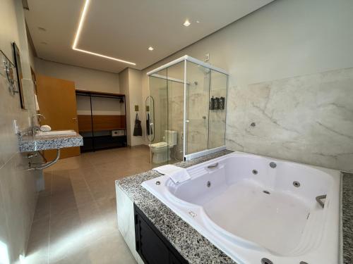 a large bathroom with a large tub and a shower at BALSAS PREMIER HOTEL in Balsas