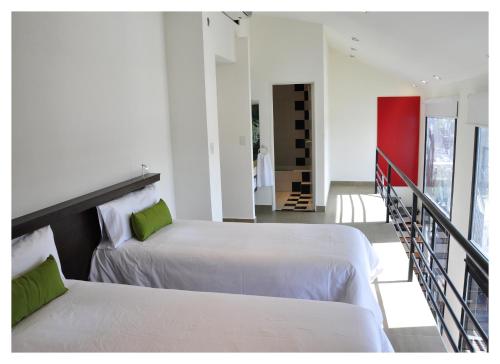 two beds in a room with a staircase at Apart Maral Zárate in Zárate