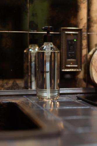 a bottle of perfume sitting on a counter at Romantic AFrame Cabin with Firepit, BBQ in Pocono Pines