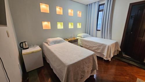 a hospital room with two beds and a window at Mendes Residence in Belém