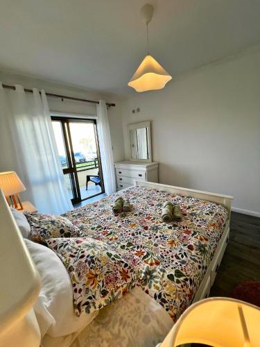 a bedroom with a bed with pillows on it at Azurara Beach in Vila do Conde