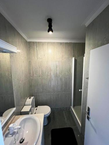 a bathroom with a toilet and a sink and a shower at Azurara Beach in Vila do Conde