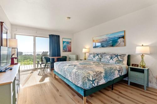 a bedroom with a bed and a large window at Crescent Beach Motel in Crescent City