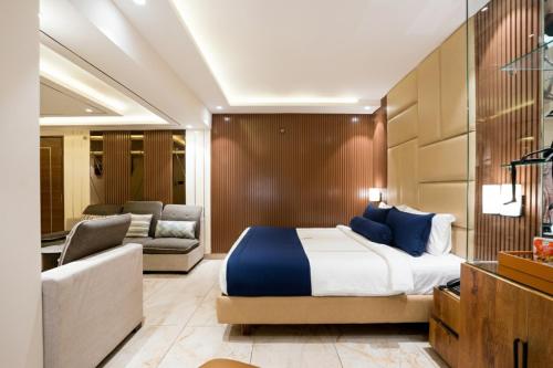 a bedroom with a bed and a living room at Hotel TOS Residency Jubilee hills in Hyderabad