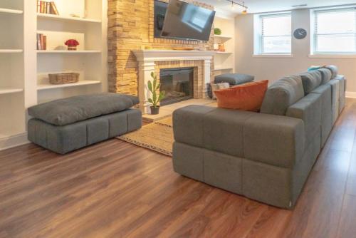 a living room with a couch and a fireplace at Lovely CWE 2BR with Private Parking ABODEbucks in Saint Louis