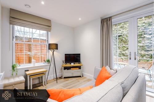 a living room with a couch and a tv at Rock Mill - Superior Apartment with Private Patio in Stony Middleton